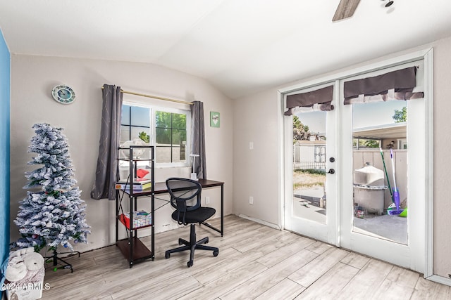 office with light hardwood / wood-style flooring and vaulted ceiling