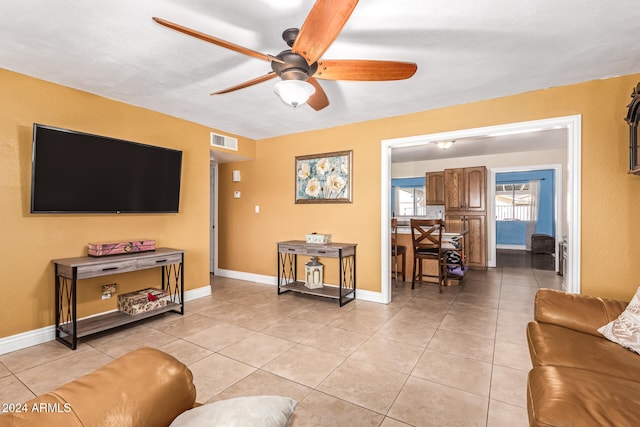 living room featuring light tile patterned floors and ceiling fan