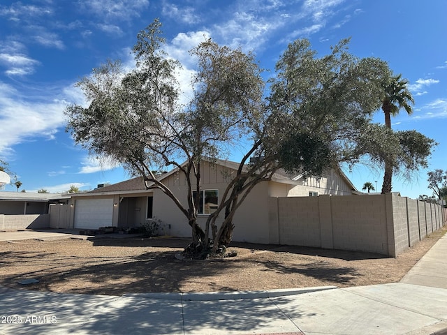 view of front of house with a garage and a fenced front yard