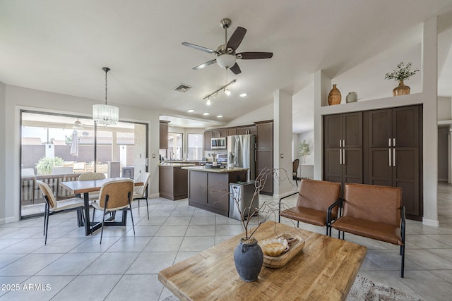 1461 W Tara Dr, Gilbert, AZ 85233 - living area featuring a ceiling fan, light tile patterned floors, baseboards, and vaulted ceiling