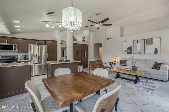1461 W Tara Dr, Gilbert, AZ 85233 - dining area featuring lofted ceiling, arched walkways, light tile patterned flooring, ceiling fan, and a chandelier
