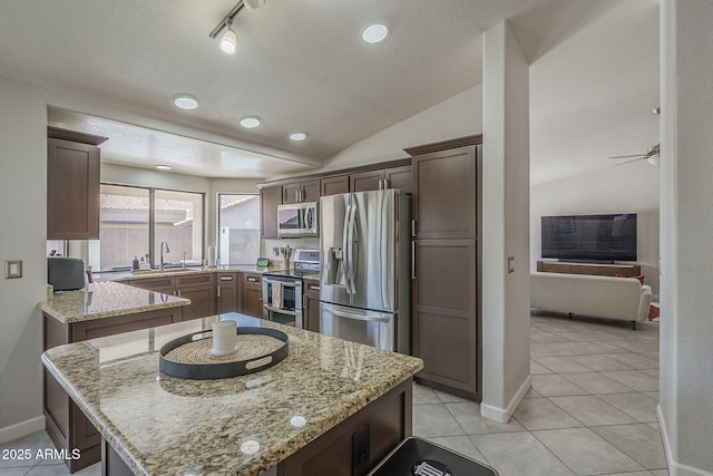 1461 W Tara Dr, Gilbert, AZ 85233 - kitchen featuring stainless steel appliances, light stone countertops, baseboards, a sink, and a center island