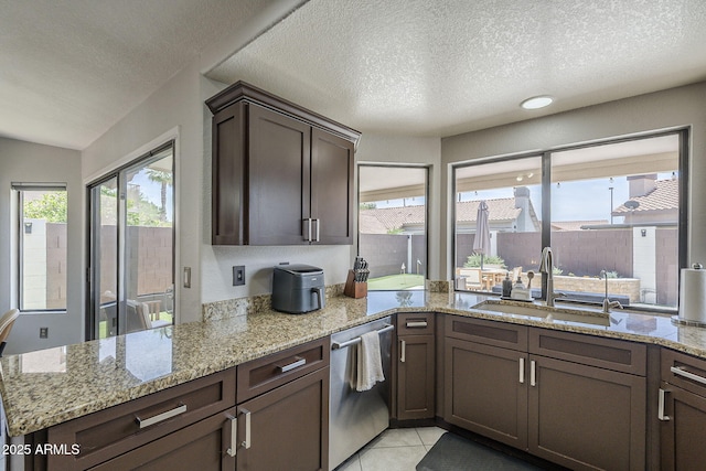 1461 W Tara Dr, Gilbert, AZ 85233 - kitchen featuring stainless steel dishwasher, a sink, a textured ceiling, and light stone countertops