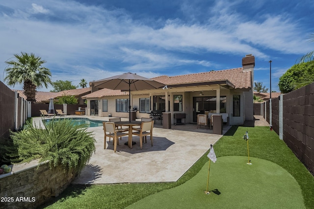 1461 W Tara Dr, Gilbert, AZ 85233 - back of property featuring a putting area, a tile roof, a fenced backyard, and stucco siding