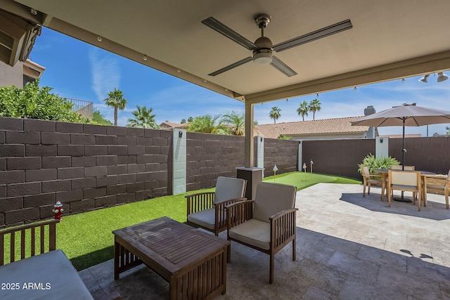 1461 W Tara Dr, Gilbert, AZ 85233 - fenced backyard with an area to practice putting, a patio, a ceiling fan, and outdoor dining area