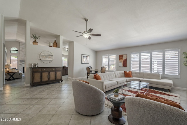 1461 W Tara Dr, Gilbert, AZ 85233 - living area with baseboards, healthy amount of natural light, ceiling fan, light tile patterned floors, and high vaulted ceiling