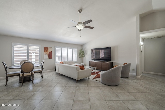 1461 W Tara Dr, Gilbert, AZ 85233 - living room with lofted ceiling, ceiling fan, baseboards, and light tile patterned flooring