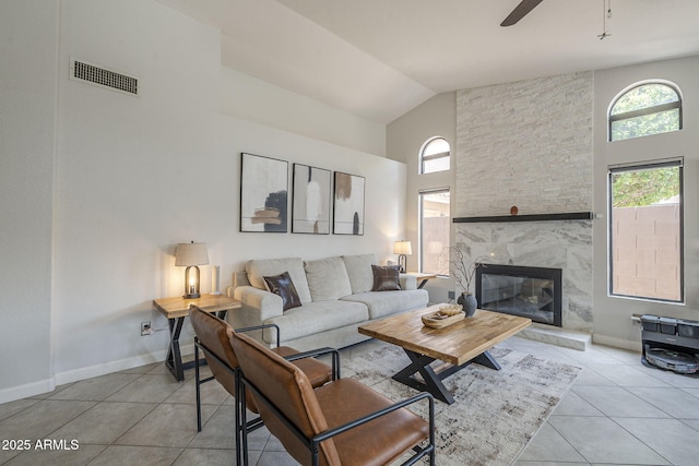 1461 W Tara Dr, Gilbert, AZ 85233 - living area featuring light tile patterned floors, high vaulted ceiling, a ceiling fan, a premium fireplace, and baseboards