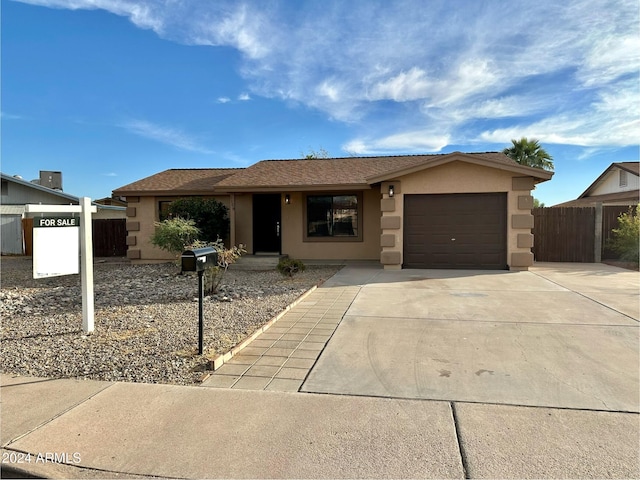 ranch-style home featuring a garage