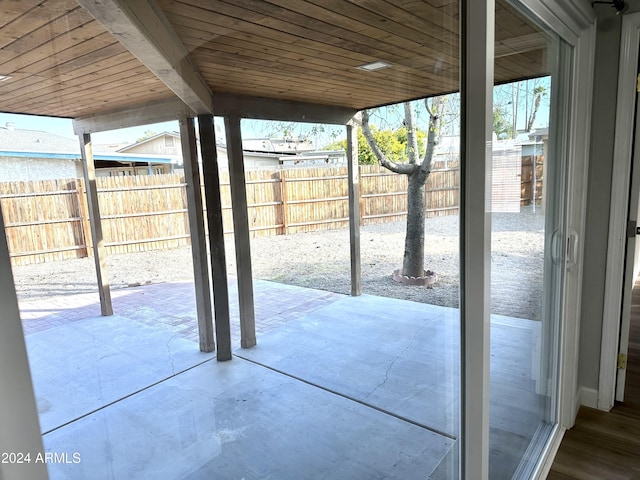 entryway featuring beamed ceiling and wooden ceiling