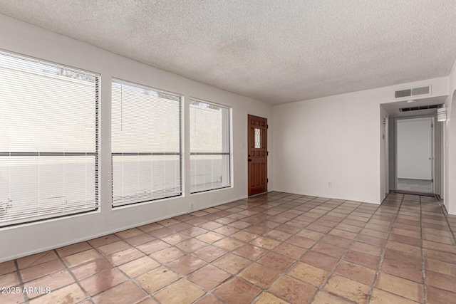 spare room featuring a textured ceiling