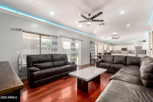 living room with visible vents, a ceiling fan, crown molding, recessed lighting, and dark wood-type flooring