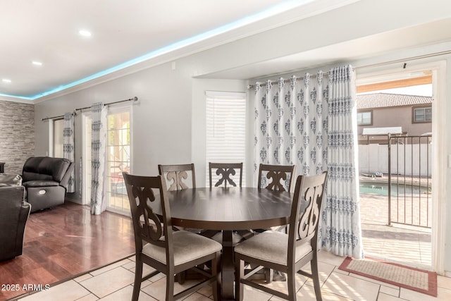 dining room with recessed lighting, ornamental molding, and wood finished floors