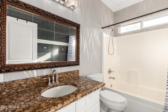 bathroom featuring toilet, crown molding, vanity, and shower / tub combination