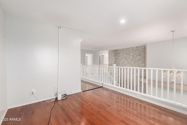 empty room with wood finished floors and recessed lighting