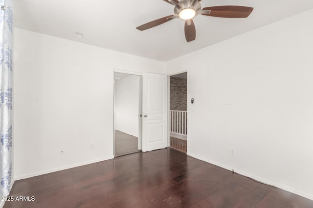 unfurnished room featuring ceiling fan, baseboards, and wood finished floors