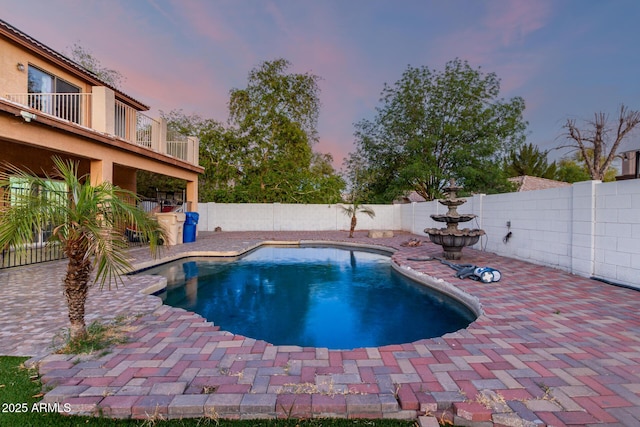 view of swimming pool with a patio area, a fenced backyard, and a fenced in pool