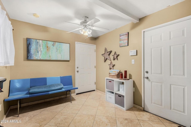 tiled foyer featuring ceiling fan and beamed ceiling