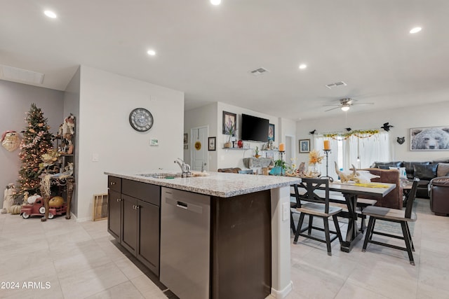 kitchen with dark brown cabinetry, ceiling fan, dishwasher, sink, and an island with sink