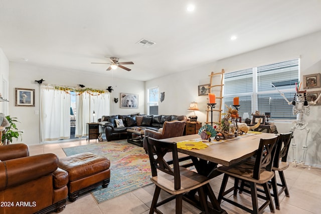 dining space with ceiling fan and light tile patterned floors