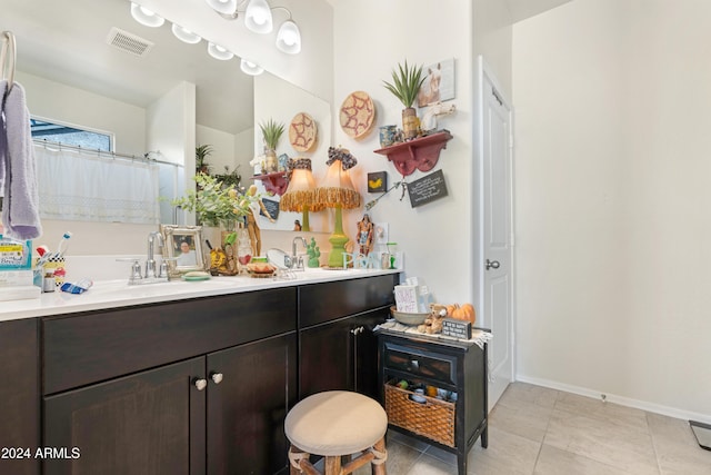 bathroom featuring tile patterned floors, vanity, and walk in shower