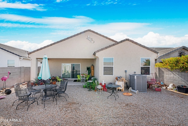 back of property with cooling unit and a patio area