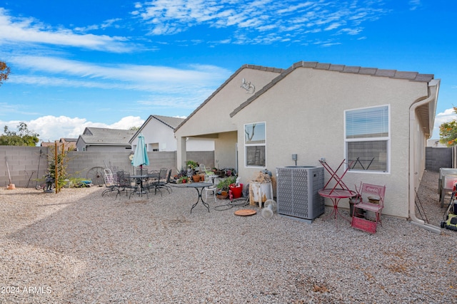 rear view of house with a patio and cooling unit