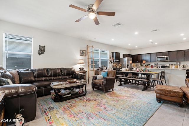 tiled living room featuring ceiling fan