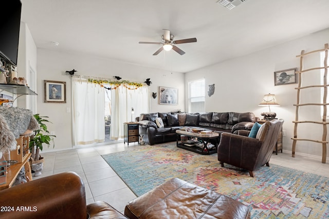 living room featuring light tile patterned floors and ceiling fan