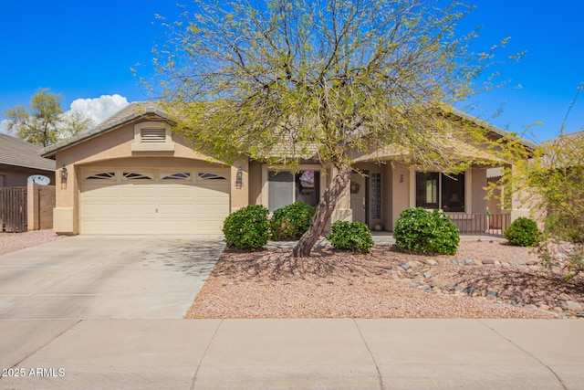 15994 W Bartlett Ave, Goodyear, AZ 85338 - obstructed view of property featuring concrete driveway, stucco siding, covered porch, and a garage