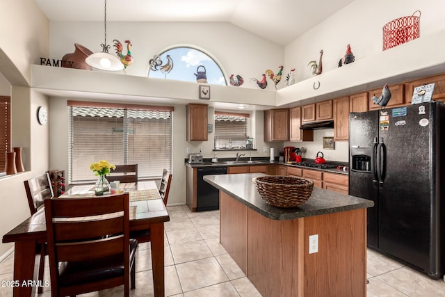 15994 W Bartlett Ave, Goodyear, AZ 85338 - kitchen featuring dark countertops, black appliances, brown cabinets, high vaulted ceiling, and a sink
