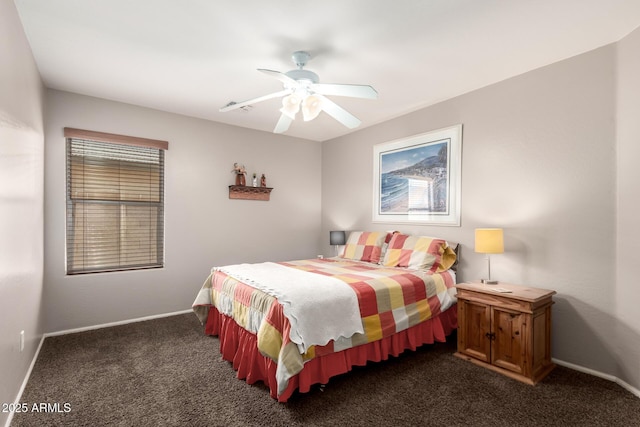 15994 W Bartlett Ave, Goodyear, AZ 85338 - bedroom with dark colored carpet, baseboards, and ceiling fan