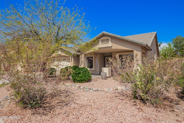 15994 W Bartlett Ave, Goodyear, AZ 85338 - ranch-style house with stucco siding, a tiled roof, and covered porch