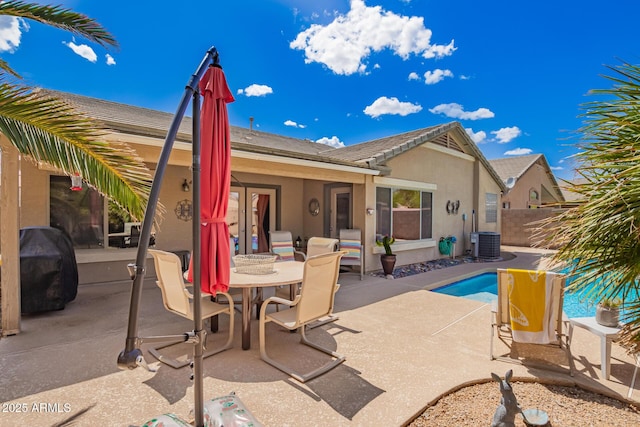 15994 W Bartlett Ave, Goodyear, AZ 85338 - rear view of house featuring outdoor dining space, stucco siding, central air condition unit, an outdoor pool, and a patio area