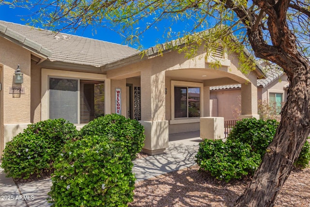 15994 W Bartlett Ave, Goodyear, AZ 85338 - doorway to property featuring stucco siding and a tiled roof