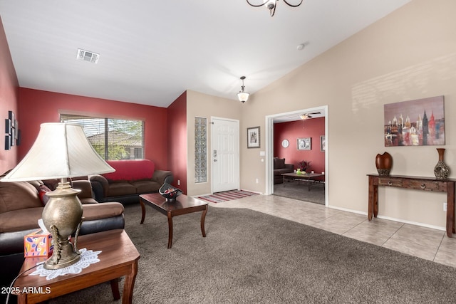 15994 W Bartlett Ave, Goodyear, AZ 85338 - tiled living room featuring carpet flooring, visible vents, baseboards, and vaulted ceiling