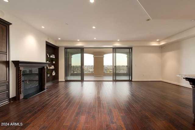 unfurnished living room with dark hardwood / wood-style flooring