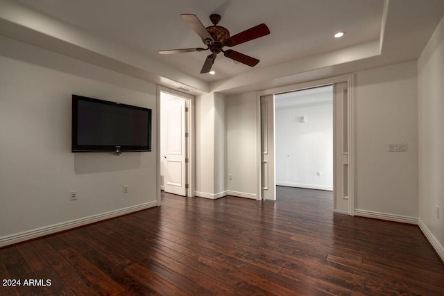 empty room with dark hardwood / wood-style floors and ceiling fan