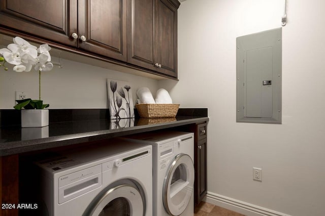 laundry room featuring cabinets, separate washer and dryer, and electric panel