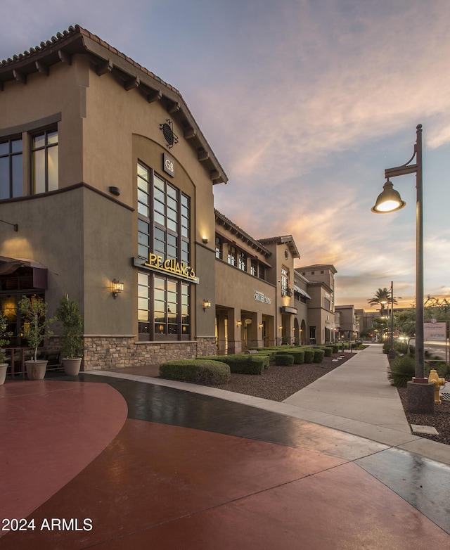 view of outdoor building at dusk