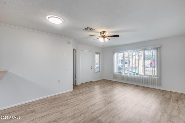 unfurnished room with ceiling fan, light hardwood / wood-style flooring, crown molding, and a textured ceiling