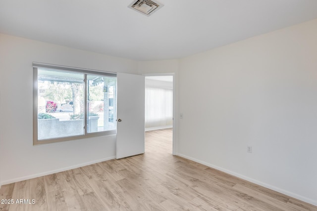 empty room with light hardwood / wood-style flooring