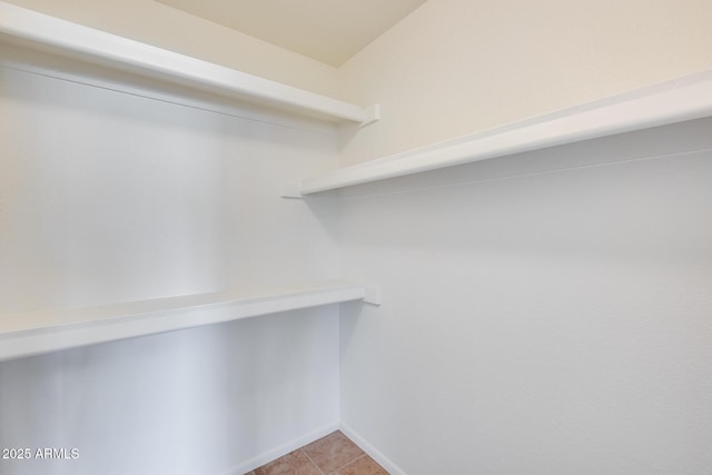 spacious closet featuring light tile patterned flooring