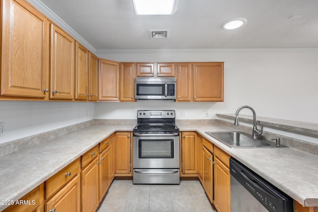 kitchen featuring crown molding, sink, light tile patterned flooring, and appliances with stainless steel finishes