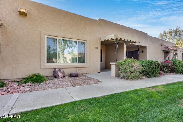 pueblo-style home with a front lawn