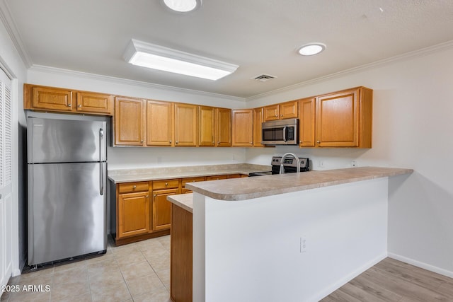 kitchen with kitchen peninsula, appliances with stainless steel finishes, and crown molding