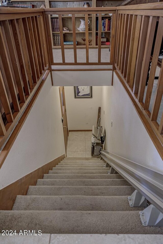 stairway with tile patterned flooring