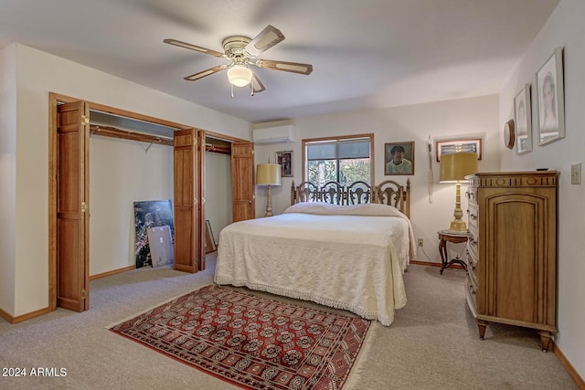 carpeted bedroom with ceiling fan and a wall mounted air conditioner