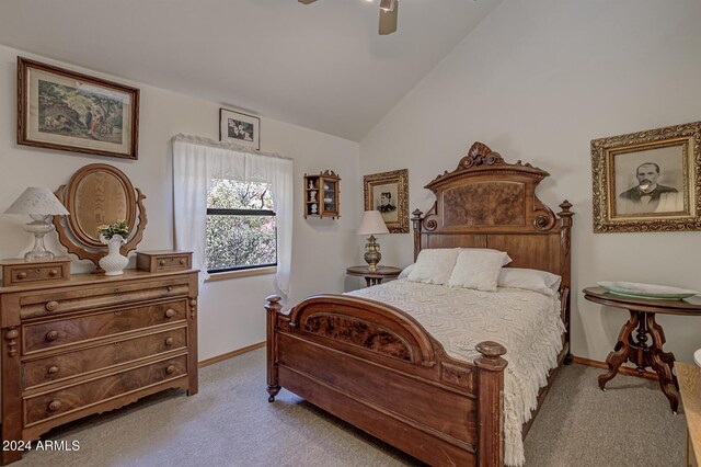 carpeted bedroom with ceiling fan and vaulted ceiling