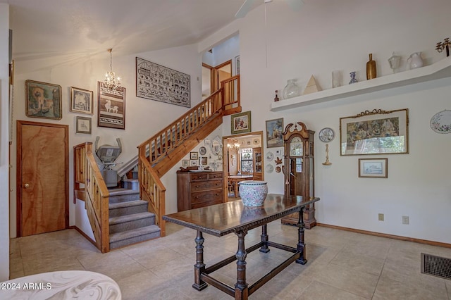 staircase featuring an inviting chandelier and tile patterned flooring